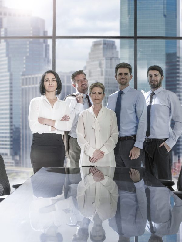 Portrait of confident businessmen and businesswomen in conference room